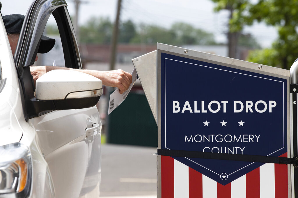 A voter drops off their mail-in ballot in Willow Grove, Pa., on May 27. (AP Photo/Matt Rourke)