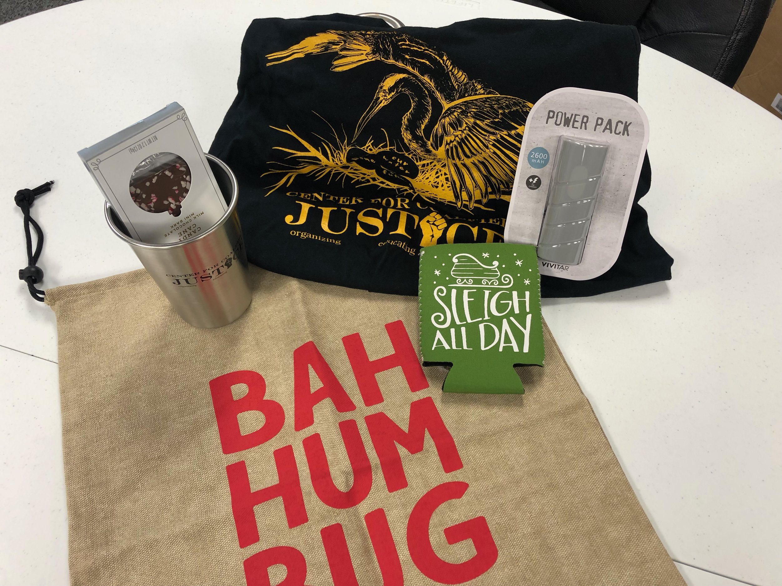 Ugly Sweater Contest Prize: CCJ tshirt and clean kanteen mug, peppermint chocolate, portable power pack, holiday coozie, and Bah Hum Bug gift bag.